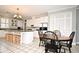 Kitchen with an island, table and chairs, and white cabinets at 1821 Stanley St, Longwood, FL 32750