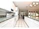 Long kitchen with white cabinets, granite counters and stainless steel appliances at 1821 Stanley St, Longwood, FL 32750