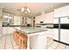 Bright kitchen featuring a center island with seating, granite countertops, and modern appliances at 1821 Stanley St, Longwood, FL 32750