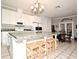 Bright kitchen featuring a large island with seating and white cabinets, perfect for modern living at 1821 Stanley St, Longwood, FL 32750
