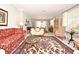 Elegant living room with a patterned rug, comfortable seating, and natural light streaming through the windows at 1821 Stanley St, Longwood, FL 32750