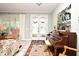 Comfortable living room features a piano, tiled floors, and plenty of natural light from the front doors at 1821 Stanley St, Longwood, FL 32750