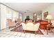 The well-lit living room has tile floors, comfortable seating, and a view of the entryway and piano at 1821 Stanley St, Longwood, FL 32750