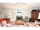 Relaxing living room with a fireplace, classic furnishings, and a ceiling fan for added comfort at 1821 Stanley St, Longwood, FL 32750