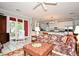 Open-concept living room showcasing a kitchen, comfortable seating, natural light, and white tile flooring at 1821 Stanley St, Longwood, FL 32750