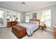 Bright main bedroom with a ceiling fan, french doors to the screened porch, and large windows at 1821 Stanley St, Longwood, FL 32750