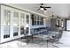 Spacious covered patio with multiple seating areas, ceiling fans, and ping pong table at 1821 Stanley St, Longwood, FL 32750