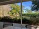 Covered patio with outdoor chairs overlooking a well-maintained lawn and landscape at 1821 Stanley St, Longwood, FL 32750
