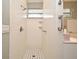 Bright tiled shower stall featuring a window and a black and white tiled floor pattern at 1821 Stanley St, Longwood, FL 32750