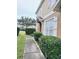 Townhome side entrance with walkway and green shrubs at 1976 Estancia Cir # 1976, Kissimmee, FL 34741