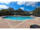 Community pool with lounge chairs and patio at 1976 Estancia Cir # 1976, Kissimmee, FL 34741