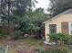 Backyard with lush greenery, a small shed, and a wooden fence at 206 Tangerine Pl, Maitland, FL 32751