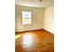 Simple bedroom with hardwood floors and a window offering natural light at 206 Tangerine Pl, Maitland, FL 32751