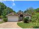 One-story house with a two-car garage and well-maintained landscaping at 2104 Cranberry Isles Way, Apopka, FL 32712