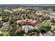 Aerial view of community clubhouse, pool, and tennis courts at 2310 Grasmere Cir, Clermont, FL 34711