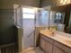 Bathroom with double vanity, shower, and a step-in shower at 2310 Grasmere Cir, Clermont, FL 34711