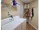 Laundry room with washer, dryer, and storage shelving at 2310 Grasmere Cir, Clermont, FL 34711