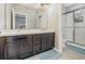 Well-lit bathroom boasts a double sink vanity with plenty of counter space and a glass-enclosed shower at 2583 Sedge Grass Way, Orlando, FL 32824