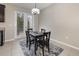 Small dining area with a dark wooden table and four chairs near sliding doors at 2583 Sedge Grass Way, Orlando, FL 32824