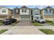 Row of townhouses with attached garages and neatly landscaped yards at 2583 Sedge Grass Way, Orlando, FL 32824