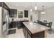 Modern kitchen with dark wood cabinets, granite countertops and stainless steel appliances at 2583 Sedge Grass Way, Orlando, FL 32824