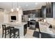 Modern kitchen features sleek black cabinetry, stainless steel appliances, and a center island with granite countertops at 2583 Sedge Grass Way, Orlando, FL 32824