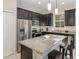 Modern kitchen with dark cabinetry, granite countertops, and stainless steel appliances at 2583 Sedge Grass Way, Orlando, FL 32824