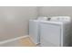 Bright laundry room with washer, dryer, and overhead shelving at 2583 Sedge Grass Way, Orlando, FL 32824