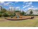 Community playground with slide, climbing wall, and benches, set against a blue sky at 2583 Sedge Grass Way, Orlando, FL 32824