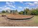 Community playground with climbing structure and bench seating, surrounded by green space at 2583 Sedge Grass Way, Orlando, FL 32824