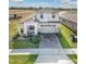 Two-story house with a two-car garage and a view of the street at 2709 Greenlands St, St Cloud, FL 34772