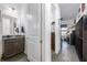 Small bathroom with granite vanity and view into hallway at 2709 Greenlands St, St Cloud, FL 34772