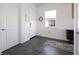 Bright entryway with dark gray wood-look flooring and small rug at 2709 Greenlands St, St Cloud, FL 34772