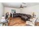 Spacious living room featuring wood floors, ceiling fan, and natural light at 2825 Greenfield Ave, Orlando, FL 32808