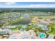 Panoramic aerial view featuring resort amenities, a large lake, and colorful homes in the community at 3020 Latitude Ln, Kissimmee, FL 34747