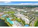 Aerial view of a waterpark, hotel, and shopping center resort with large pool area and a lake at 3020 Latitude Ln, Kissimmee, FL 34747