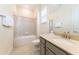 This bathroom features a shower/tub combination, a sink with light colored countertop, and tile flooring at 3020 Latitude Ln, Kissimmee, FL 34747