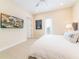 This bedroom features tile floors, a king bed, and a wall-mounted flat screen television at 3020 Latitude Ln, Kissimmee, FL 34747