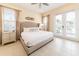 Bright bedroom featuring tile floors, a ceiling fan, and a king bed with neutral-toned furnishings at 3020 Latitude Ln, Kissimmee, FL 34747