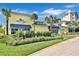 Exterior view of the Fins Up Fitness Center with blue awnings and lush landscaping at 3020 Latitude Ln, Kissimmee, FL 34747