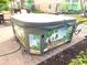 Close-up of a 'Margaritaville' themed hot tub on a brick patio; perfect for relaxation at 3020 Latitude Ln, Kissimmee, FL 34747