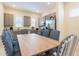 A kitchen and dining area with gray cabinets, stainless steel appliances, and seating for six at 3020 Latitude Ln, Kissimmee, FL 34747