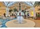 Stunning open lobby with high ceilings, many palm trees and chandeliers with lounging areas at 3020 Latitude Ln, Kissimmee, FL 34747