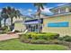 Exterior view of the St. Somewhere Spa, with blue awnings and plenty of lush landscaping at 3020 Latitude Ln, Kissimmee, FL 34747