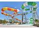 Thrilling water park slides with towering structures under a clear blue sky at 3020 Latitude Ln, Kissimmee, FL 34747