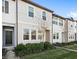 Two-story townhome with dark gray door and neutral colored siding at 3092 Water Sprite St, Orlando, FL 32808