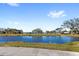 Scenic view of a lake with lush trees at 3092 Water Sprite St, Orlando, FL 32808