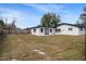 Large backyard with newly renovated home and wooden fence at 3118 Clemwood St, Orlando, FL 32803