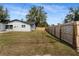 Long backyard with a newly renovated home and wooden fence at 3118 Clemwood St, Orlando, FL 32803