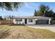 Newly renovated home with a modern farmhouse exterior, featuring a gray garage door and white brick at 3118 Clemwood St, Orlando, FL 32803